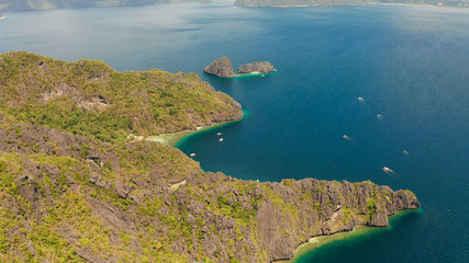 aerial view of bay and the tropical islands. Seascape with tropical rocky islands, ocean blue water. islands and mountains covered with tropical forest. El nido, Philippines, Palawan. Tropical