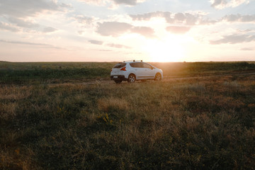 White car on the sunset horizon 