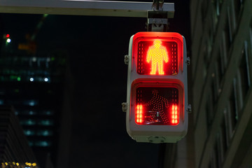 Selective focus on traffic red light for people, pedestrian and human to stop and wait and red dot...