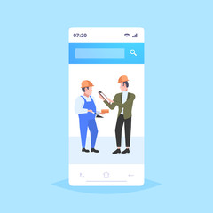 construction workers architect and foreman discussing new building project during meeting builders in helmet industrial technicians teamwork concept smartphone screen mobile app full length