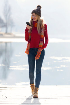 Young blond woman at a lake in winter