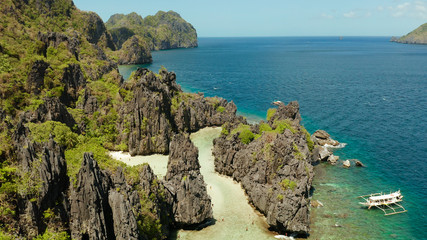 Tropical lagoon with sandy beach surrounded by cliffs. El nido, Philippines, Palawan. beautiful lagoon and karst scenery.