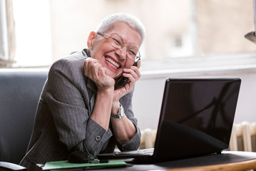 Older lady manager having a little break in her office