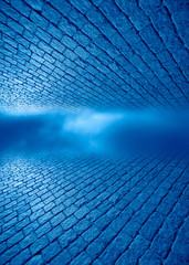 Blue space between a brick floor and ceiling.