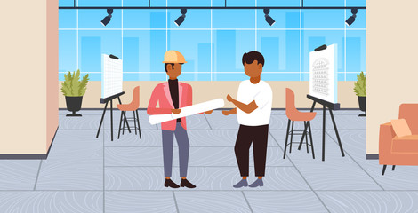 couple architects with rolled up blueprints discussing new project engineers team construction industry concept modern draftsman studio interior full length flat horizontal