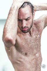 Attractive young guy taking a shower