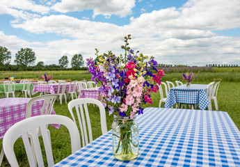 Jar of delphiniums on a table at the Confetti Flower Fields at Wick near Pershore Worcestershire 
