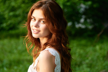 Naklejka premium beautiful woman green leaves nature park