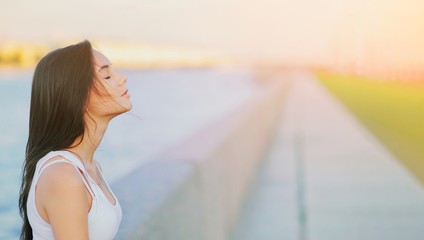 Side view profile portrait of a happy brunette woman relaxing breathing fresh air outdoors in summer Girl close eyes doing deep breath exercises. Positive emotion success, peace of mind, zen concept. - obrazy, fototapety, plakaty