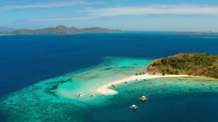 Aerial view tropical beach on island Ditaytayan. tropical island with white sand bar, palm trees and green hills. Travel tropical concept. Palawan, Philippines