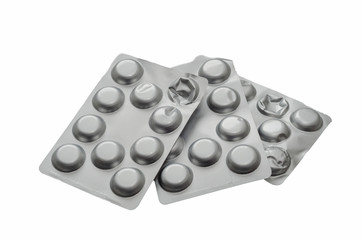 three blisters with pills on white isolated background