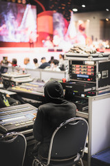 Sound engineer working at audio control panel in seminar room ,microphone meeting room Selective Focus..