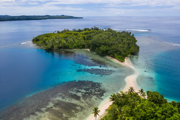 A coral reef surrounds idyllic islands off the coast of New Britain in Papua New Guinea. This area...