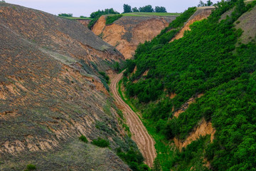 dirt road between hills, landscape