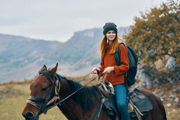 Foto op Canvas young woman riding horse © SHOTPRIME STUDIO