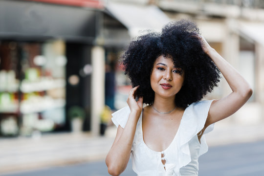 Young African American woman portrait relaxing looking at camera outdoors