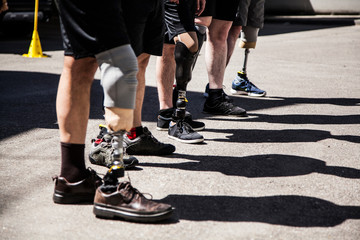 Unrecognizable group of amputees men testing their new leg prostheses