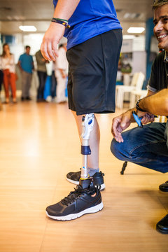 Prosthetic engineer reviewing the prosthesis of a patient and improving the material in his workshop