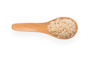 Brown rice in a wooden spoon on a white background. Top view