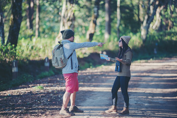 Fototapeta premium Young attractive couple hiking in the forest.