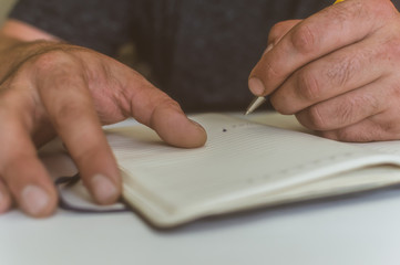a person makes an entry in a notebook for doing business