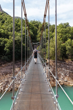 Man Doing Trekking While Crossing A Bridge