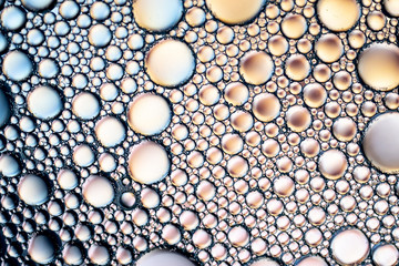 light background of soap bubbles on water macro