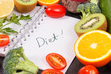 Word diet written in notepad and fruits with vegetables, healthy lifestyles concept