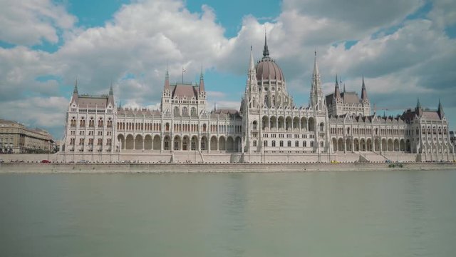 Boat ride through Danube, passing by Budapest Parliament, sunny