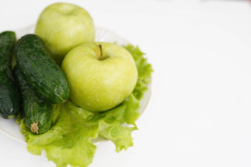 green apple and cucumber on white background, copy space. healthy lifestyle, dieting