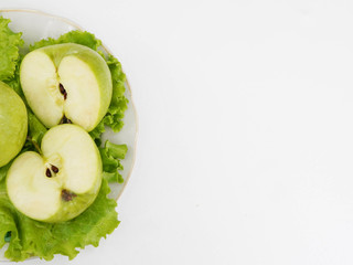 green apple on plate on white background, copy space. healthy lifestyle, concept of dieting