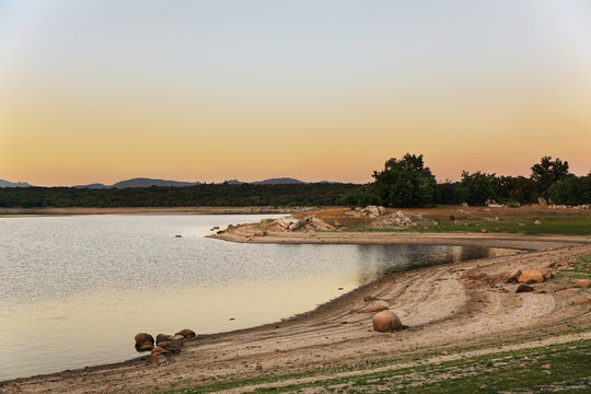 Picturesque view of lake with countryside route, fir forest and hills in Valmayor Lake Spain