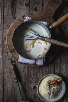 From above baking dish with corn flour for cooking on cutting board on wooden background