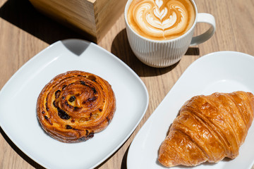 Homemade fresh croissant and cup of hot coffee espresso
