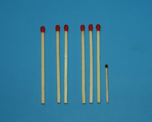 wooden matches a long match with a red tip and a short match with a black tip lie in a row