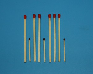 wooden matches a long match with a red tip and a short match with a black tip lie in a row