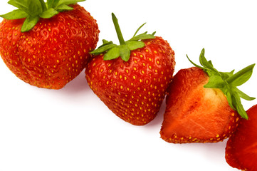 Strawberries close up. White background. Juicy fresh red berry. Chilled fruit from the fridge.