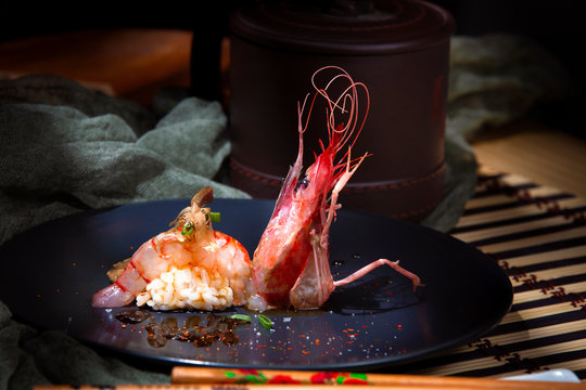 Appetizing delicious colorful prawn decorated with green at served table in restaurant