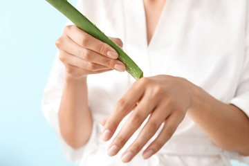 Beautiful young woman with aloe vera, closeup