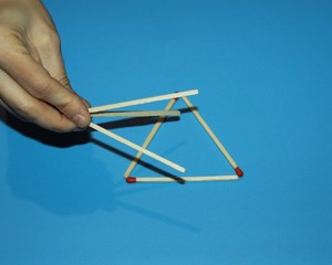 hand fingers take build collect Wooden matches solve the puzzle, volumetric triangle