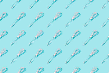 Seamless pattern made with pink baker whisk on turquoise background