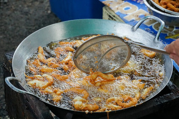 The chief fries in a boiling oil breaded chicken, Crumbed breast chicken fried in oil in a pan, Cooking concept