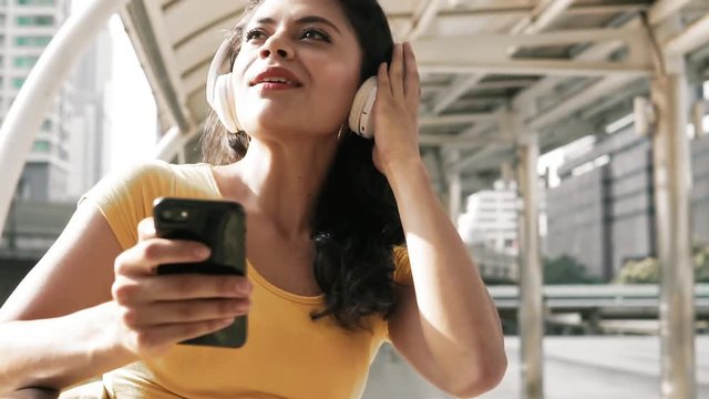 Young woman wearing headphones listening to music