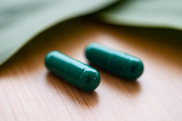 Green pills on herb concept.