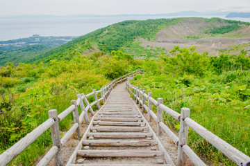Fototapeta na wymiar Viewpoint on Usu mountain in the Shikotsu-Toya National Park at Hokkaido, Japan in cloudy day of summer seasonal. (Foreign text in image is 