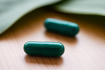 Green pills on herb concept.