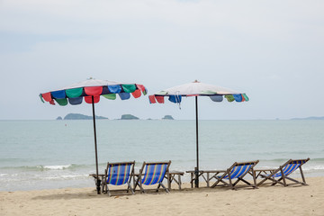 Beach chair on white sand with sea wave and sunny. Relaxing on the beach.