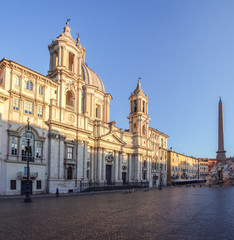 Fototapeta na wymiar Sant Agnese Church at dawn in the Piazza Navona with Egyptian obelisk and Four Rivers Foutain in the background - Rome, Italy.