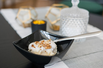 Healthy tasty food in a bowl on a plate. Cheese, yogurt and walnuts.