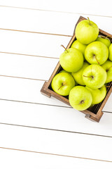 Overhead shot of green apples in wooden box